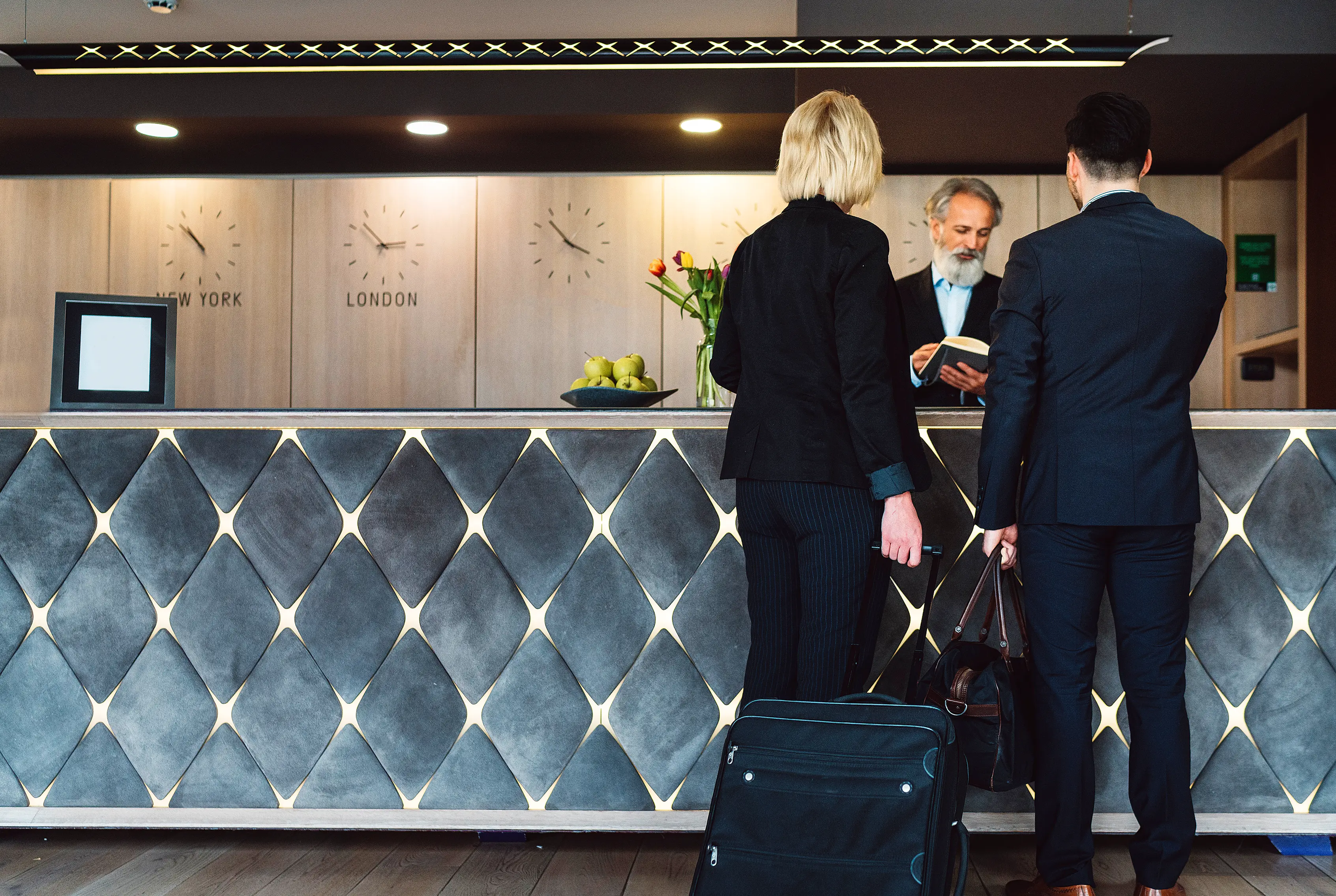 Two people checking in to a luxury hotel